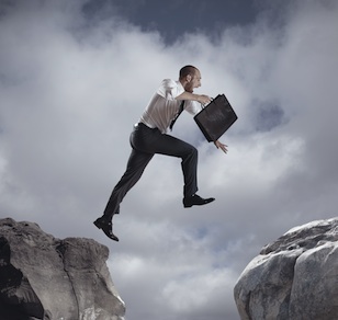 Businessman jumping over the mountains